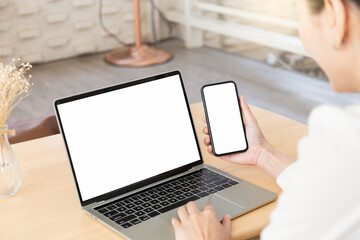 computer screen,cell phone blank mockup.hand woman work using laptop texting mobile.white background for advertising,contact business search information on desk in cafe.marketing,design