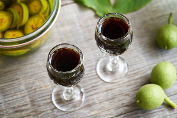 Two glasses of nut liqueur made from unripe walnuts