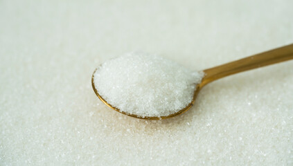 Fototapeta na wymiar Spoon with sugar on a white background