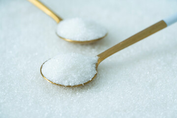 Spoon with sugar on a white background