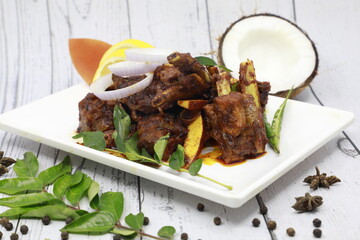 Traditional homemade Mutton curry from Asian cuisine Chukhandar gosht spicy meat beef curry coconut pieces mutton roast Indian spices. side dish Ghee rice Appam Parotta, rotti