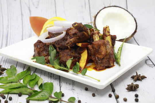 Traditional homemade Mutton curry from Asian cuisine Chukhandar gosht spicy meat beef curry coconut pieces mutton roast Indian spices. side dish Ghee rice Appam Parotta, rotti