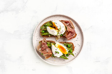 Ketogenic diet meal Poached egg with asparagus spears and prosciutto. banner, menu recipe place for text, top view