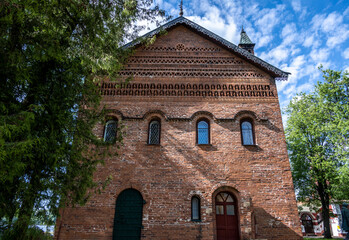 summer landscape with ancient churches against the backdrop of a forest and a river on a sunny day