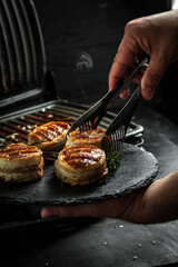 Grilled meat steak Filet Mignon with seasonings. Juicy meat steak. Beef steak grilled on dark background with spices. Ketogenic low carbs diet concept