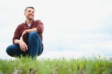 Naklejka na ściany i meble portrait of a young farmer in a field