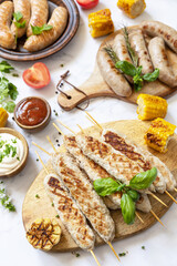 Summer party food. Grill food menu. Bbq grilled chicken kebab with fresh herbs and spices on marble tabletop.