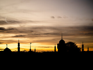 Naklejka premium Ramadan, Eid ai-fitr,New year Muharram islamic religion Symbols with silhouette mosque dome on blur dark red and orange twilight sky in night sunset. arabic,Eid al-adha,mubarak Muslim concept.