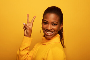 Young African American woman wearing casual sweater showing and pointing up with fingers number two