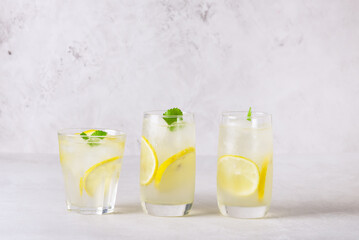 Refreshment Summer rink Tasty and Traditional Lemonade with Lemon Mint and Ice on Light Gray Horizontal