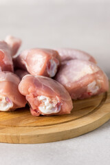 Raw Chicken Meat Legs on Wooden Tray Vertical Gray Background