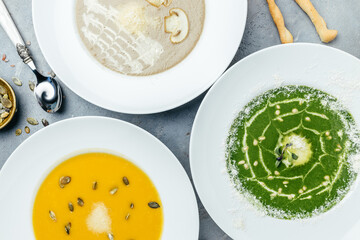 large lunch set of three soup, set menu served. Vegetarian set of soups. pumpkin and carrot soup, broccoli cream soup and mushroom soup. top view