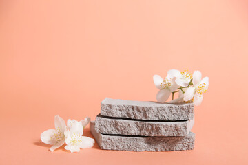 Product podium and grungy concrete stone, flower. Minimal coral background for cosmetics or products presentation. Front view.