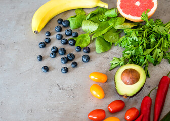 Healthy food: fruit, vegetable, superfood, leaf vegetable on gray concrete background