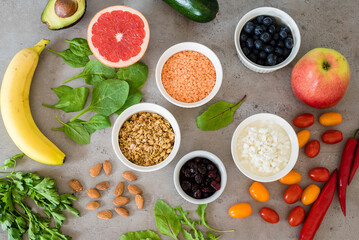 Healthy food: fruit, vegetable, superfood, leaf vegetable on gray concrete background