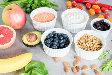 Healthy food: fruit, vegetable, superfood, leaf vegetable on gray concrete background