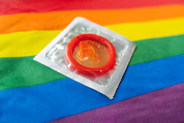 a condom on a multicolored rainbow flag. concept of safe sex.