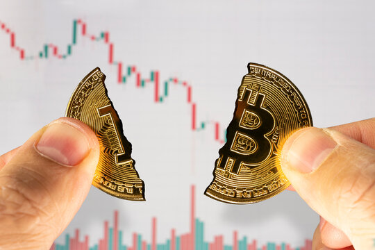 bitcoin cryptocurrency blockchain digital market on man hand and price chart background with clipping path. Concept bitcoin low price. low exchange rate of bitcoin on the stock exchange.