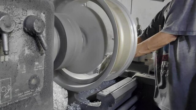 Fine turnings fly off a fast spinning metal lathe