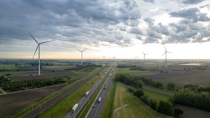 Panoramic aerial drone view of wind farm or wind park, with high wind turbines for generation...
