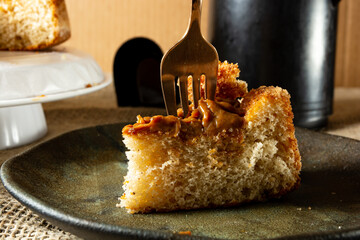 typical brazilian churros cake with dulce de leche, on a table with plates and coffee, comfortable breakfast or snack scene