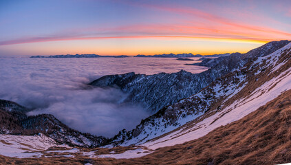 Sunset in the mountains with fog in the valley