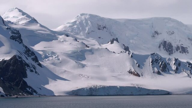 Point Of View Shot Of Snow Covered Mountains By Sea On Sunny Day - Antarctic Peninsula, Antarctica