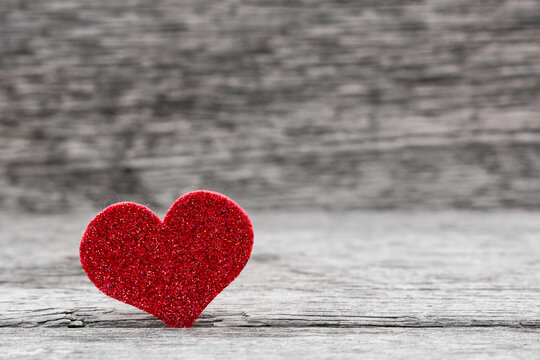 Valentine background with handmade heart on rustic wood