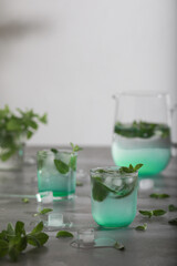 Glass of cold water with fresh mint leaves and ice cubes