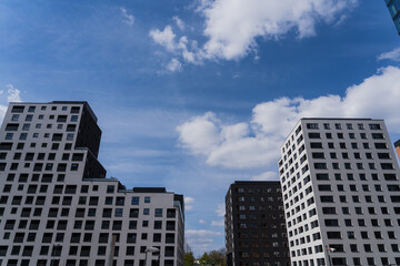Low angle view of modern buildings with blue sky at background in Wroclaw