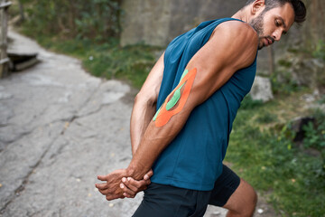 Young caucasian sports man warming up outdoors