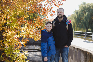 Obraz premium portrait of a happy father and son outdoors in autumn