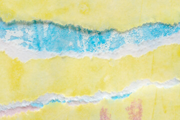 Abstract blue yellow watercolor paint on torn paper background texture