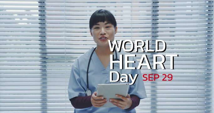 Animation of world heart day icon over asian female doctor
