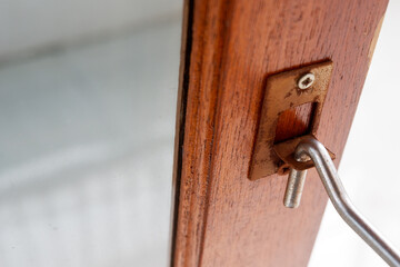 A metal window hook placed on windowsill. A steel window lock hook placed to keep the window open