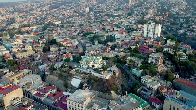 Aerial orbit of Baburizza Palace Museum and El Peral funicular in Cerro Alegre, Valparaiso hillside city, Chile