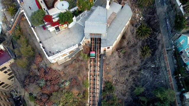 Aerial top down of carriage going up in El Peral funicular near Baburizza Palace in Cerro Alegre, Valparaiso, Chile
