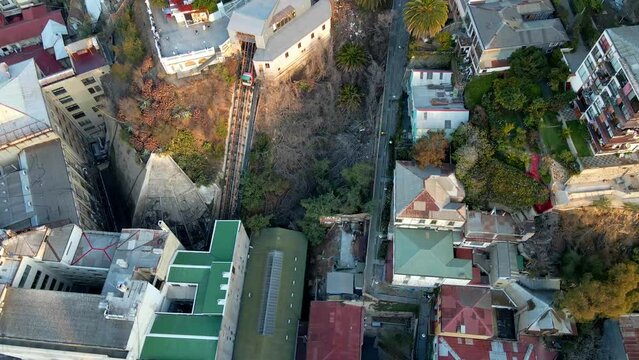 Aerial orbit of carriage going up in El Peral funicular in Cerro Alegre, Valparaiso hillside city, Chile