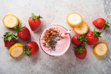 Strawberry smoothie. Vegan smoothie or milkshake from strawberry, banana and mint on white wooden table background. Clean eating, alkaline diet. Top view. Mock up.