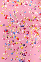 Flying small multicolored polyfoam balls, theme of holidays and birthdays.