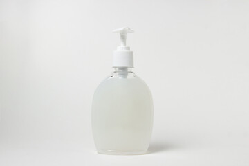 Bottle of white liquid soap on a white background. Personal hygiene. Cleaning agent