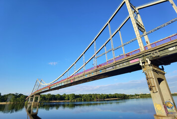 Kyiv, Ukraine - May 24, 2022: Landscape of the pedestrian bridge in Kiev. Summer time