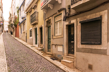 Fototapeta na wymiar Old street in Lisbon with interesting doors and windows