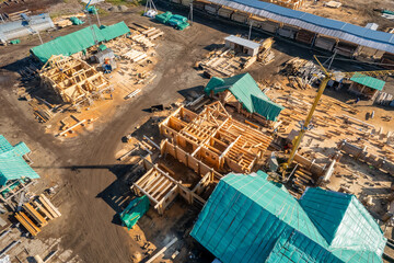 Industry site for construction of villas and houses from timber and wood. Log works aerial top view