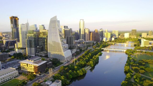 Aerial view the Austin skyline and the Colorado river, serene, summer evening in Texas, USA - rotating, pull back, drone shot