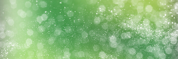 Summer green sparkling glitter bokeh background, banner texture. Abstract defocused lights header. Wide screen wallpaper. Panoramic web banner with copy space for design