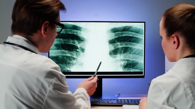 Healthcare and medicine. Doctors examining lungs x-ray close-up. Nurse and therapist looking at ribs roentgen on computer monitor, human chest, checkup. 