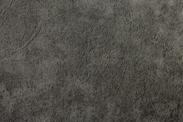 Gray background of decorative plaster with abstract spots. Unusual silver wall texture with beautiful patterns, creative surface background. Dressing coating for building cladding.