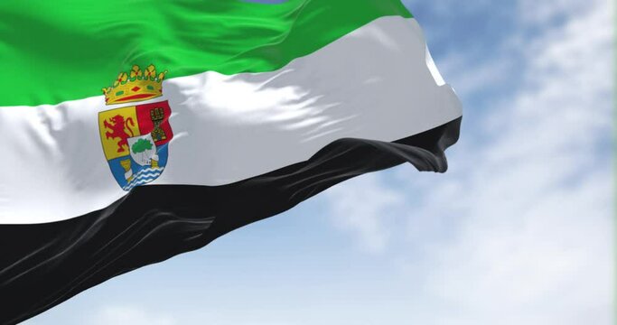 The Extremadura flag waving in the wind on a clear day