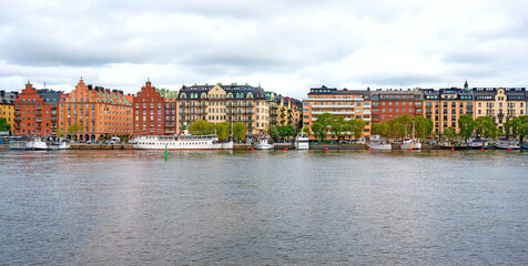 Colorful buildings and some boats on the embankment of Mälarstrand in Stockholm, Sweden